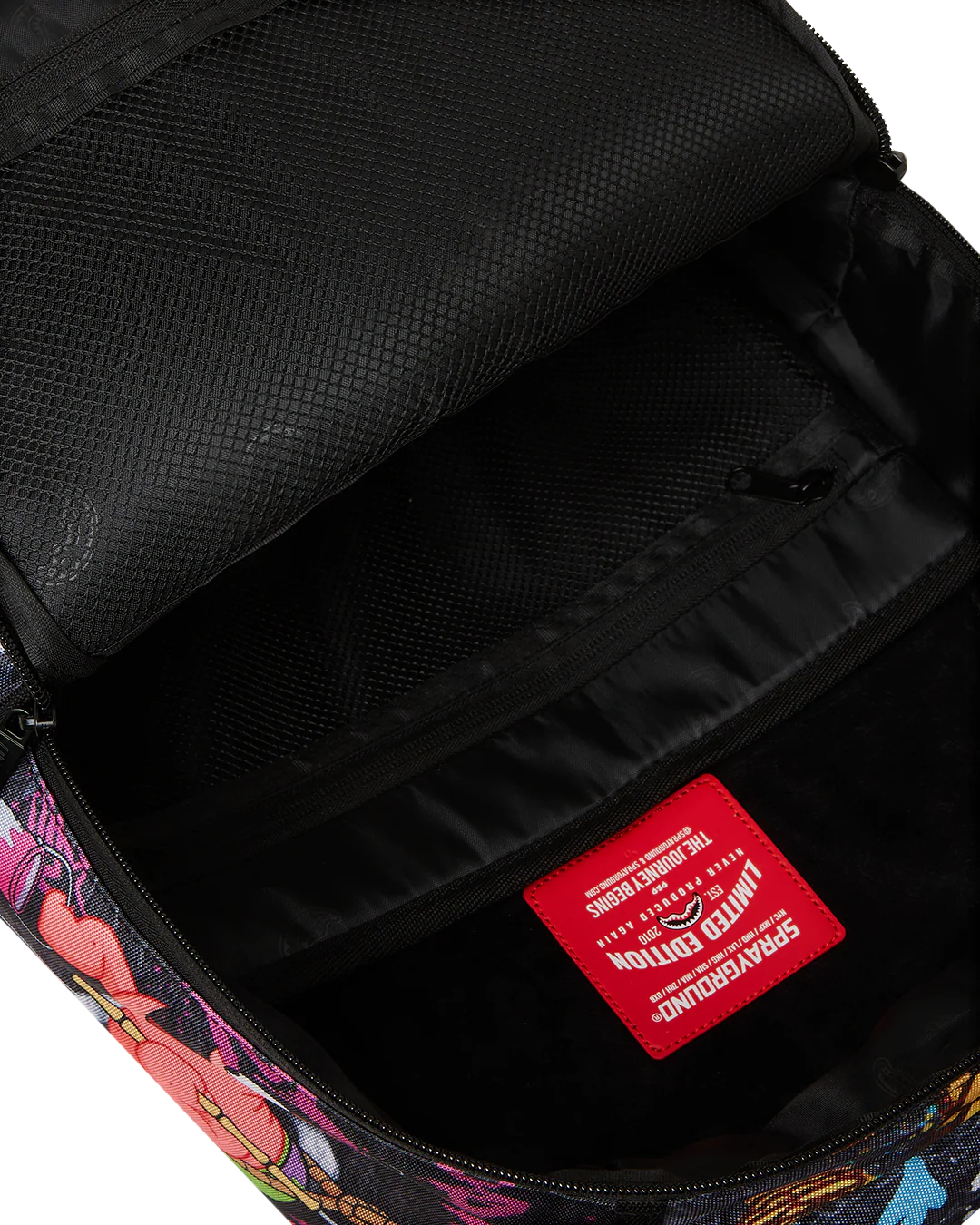 Close-up of a backpack with a colorful pattern and a red label on a black interior.