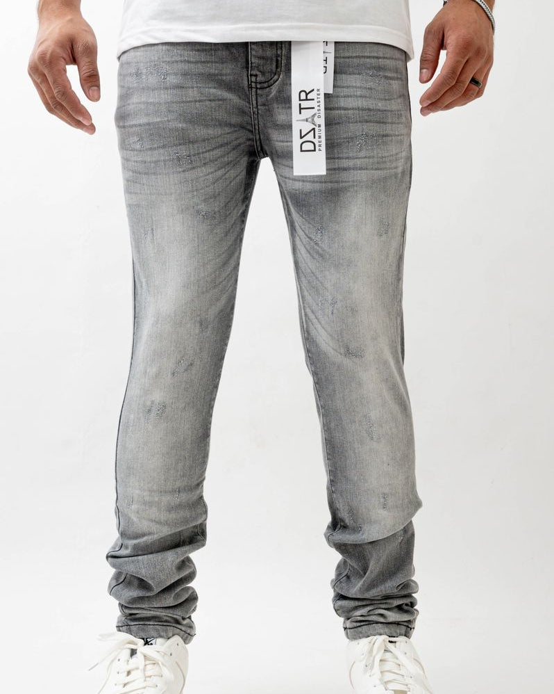 Person wearing gray jeans with a visible brand label on a white background