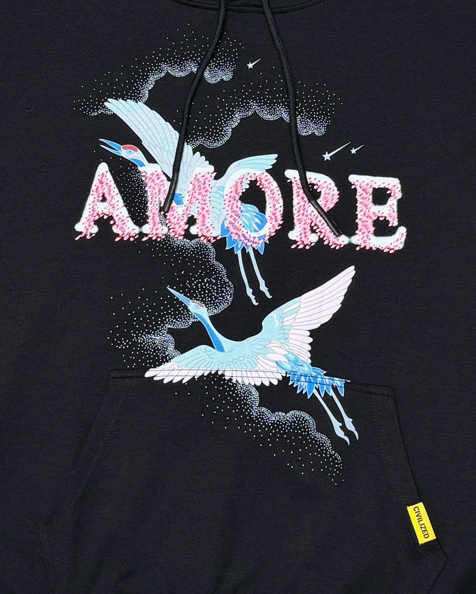 Black hoodie with 'Amore' text and bird designs on a dark background