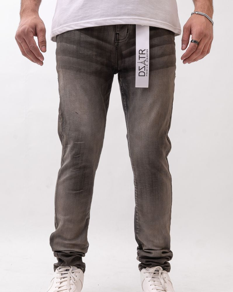 Person wearing gray jeans with a visible brand label on a white background