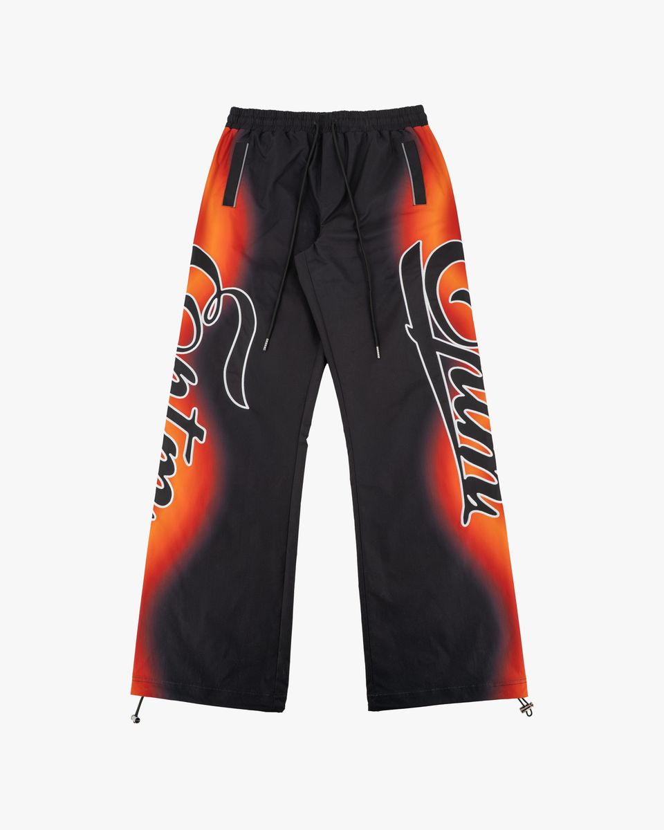Black pants with orange and red graphic design on a white background