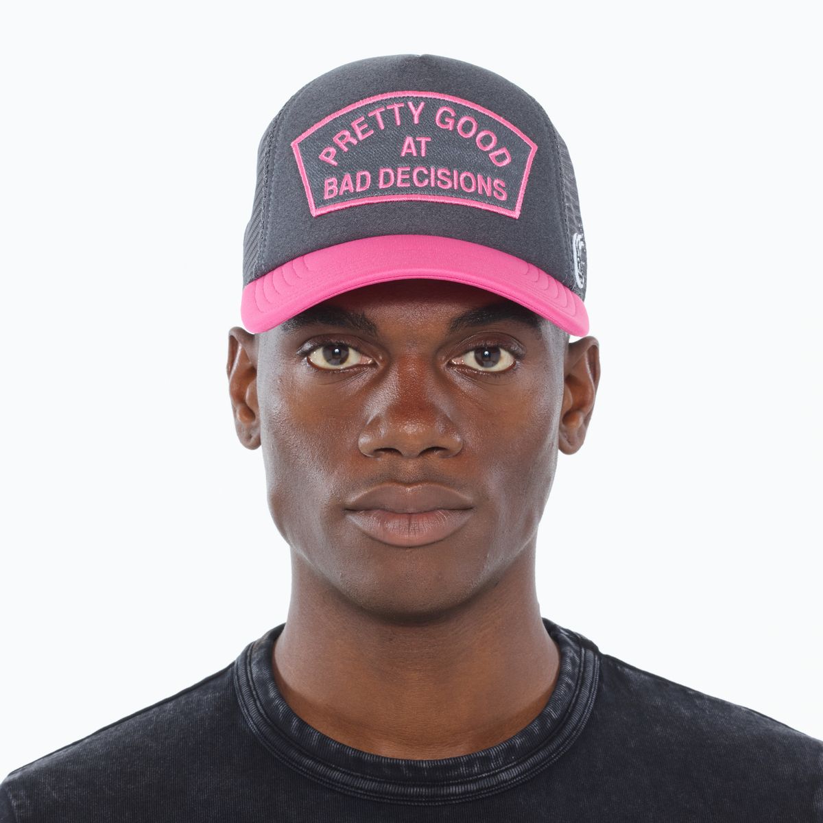 Cult of individuality Good At Bad Decisions Trucker Hat in charcoal and pink