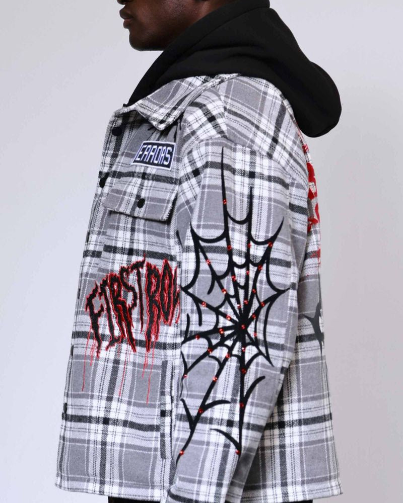 Person wearing a plaid jacket with graphic designs and text on a plain background