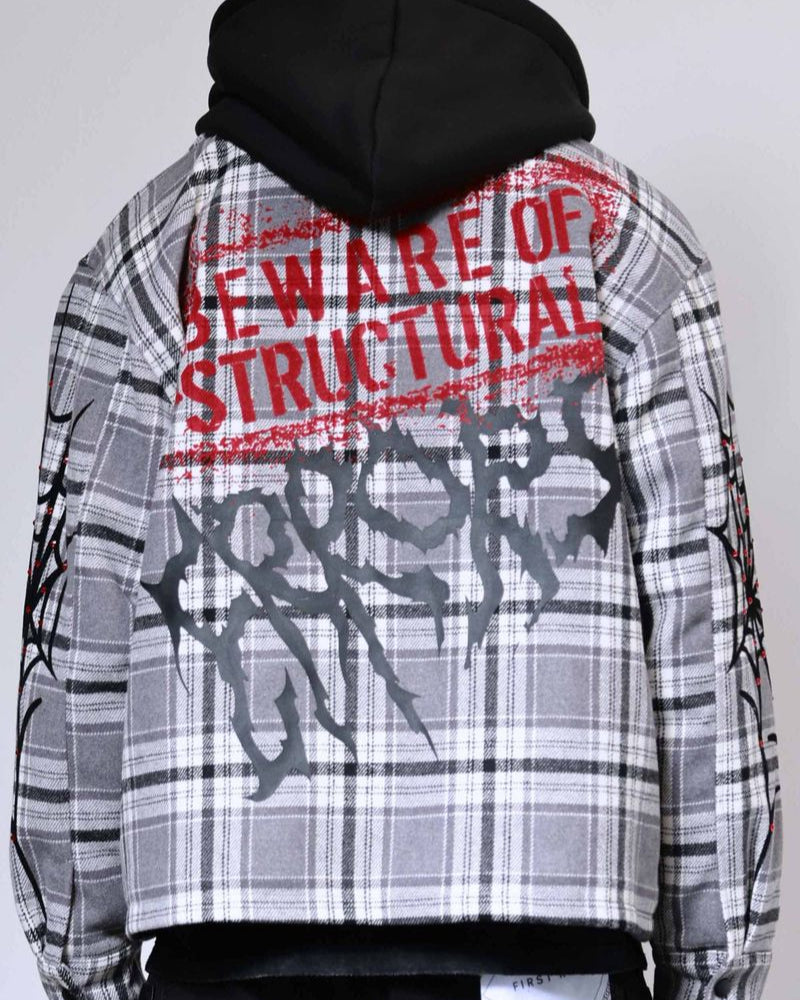 Person wearing a plaid shirt with text on the back against a plain background