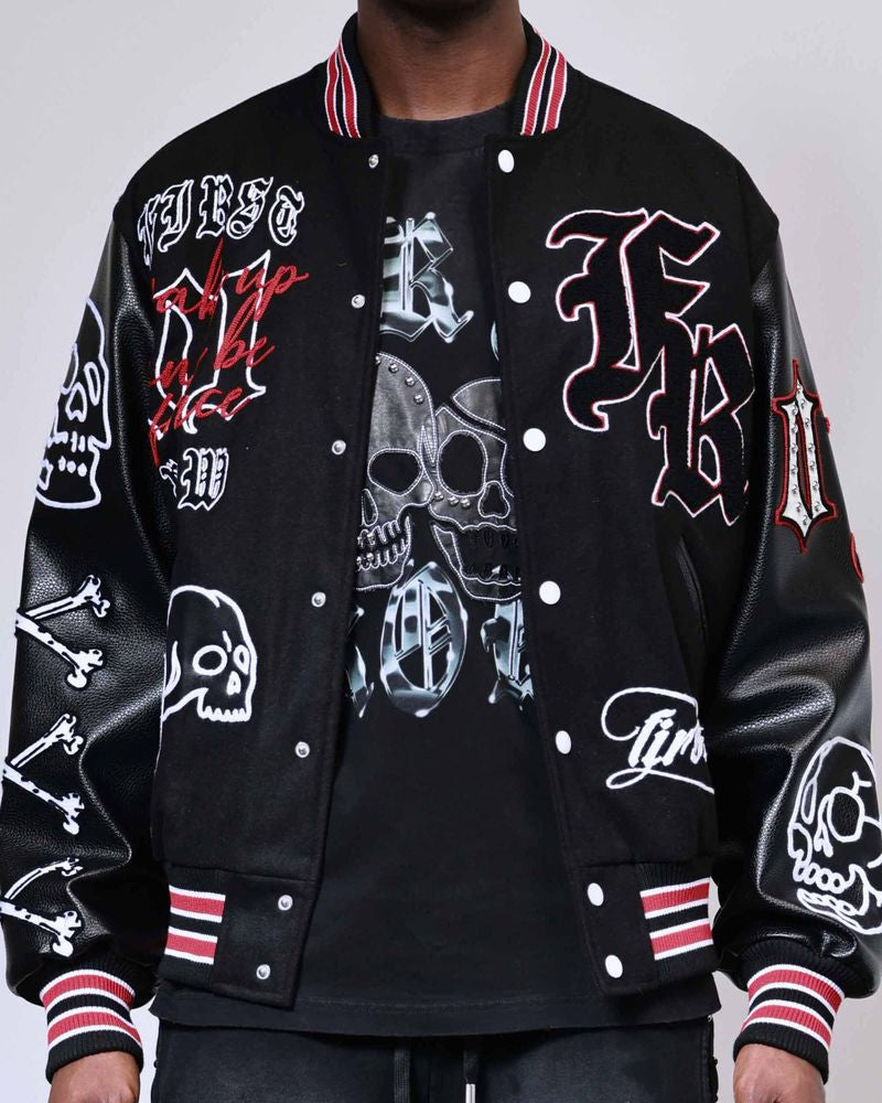 Black varsity jacket with graphic designs on a gray background