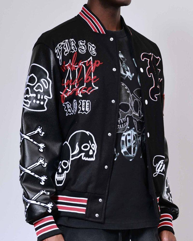 Black varsity jacket with skull and bone designs on a plain background