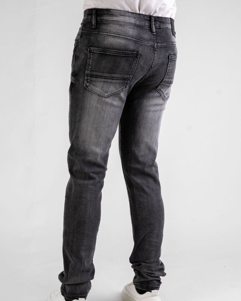 Person wearing black jeans on a white background