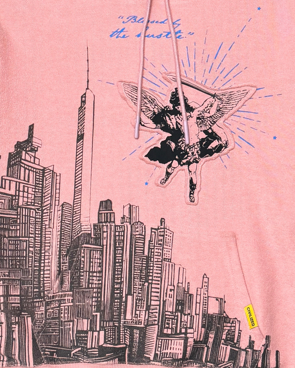 Pink sweatshirt with a cityscape and butterfly design on a pink background