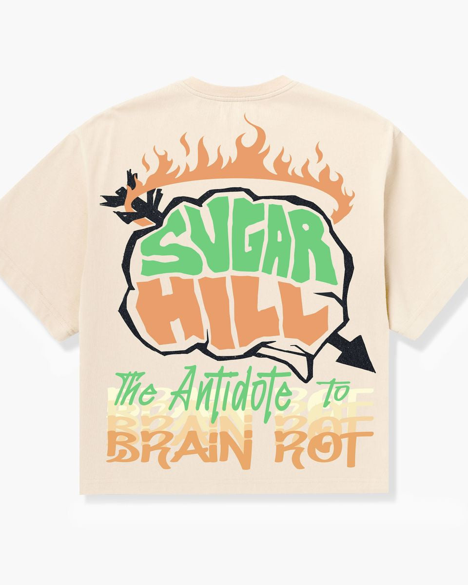 Beige t-shirt with 'Sugar Hill' and 'The Antidote to Brain Rot' text design on a white background
