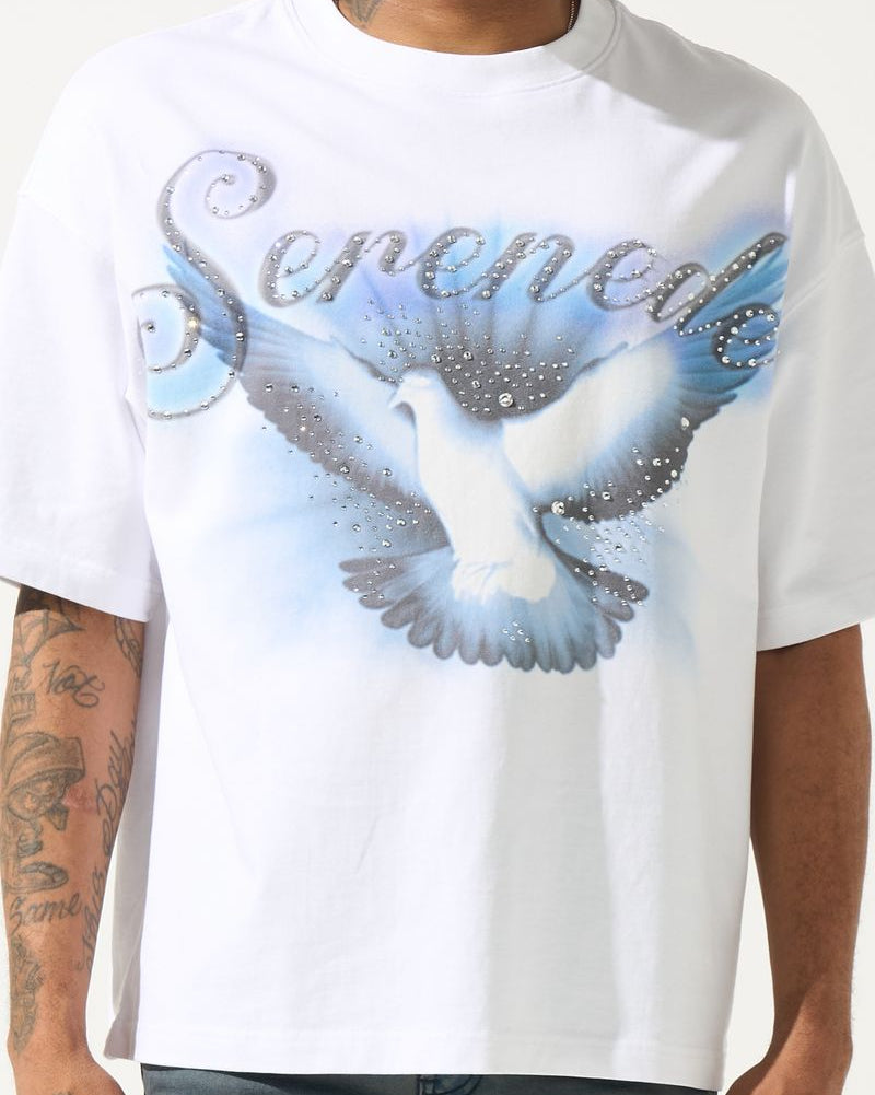 White t-shirt with a dove graphic and 'Serenade' text worn by a person.