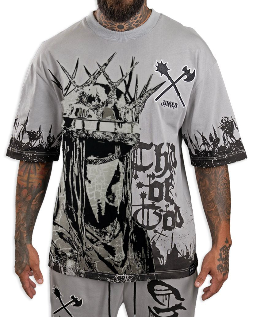 Person wearing a gray t-shirt with black graphic designs on a white background