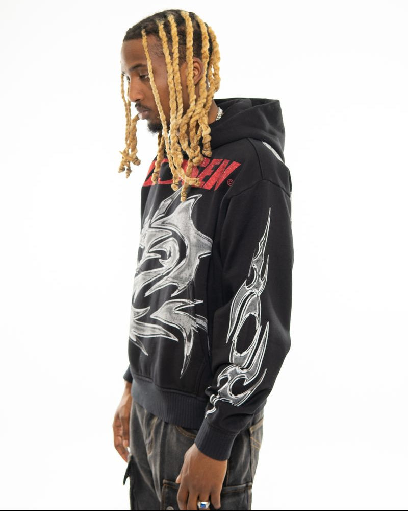 Person wearing a black hoodie with white designs on a white background