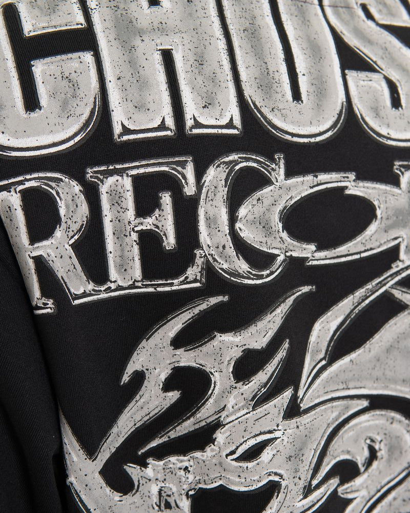 Close-up of a logo with 'GHOST RECORDS' text and a stylized face design.