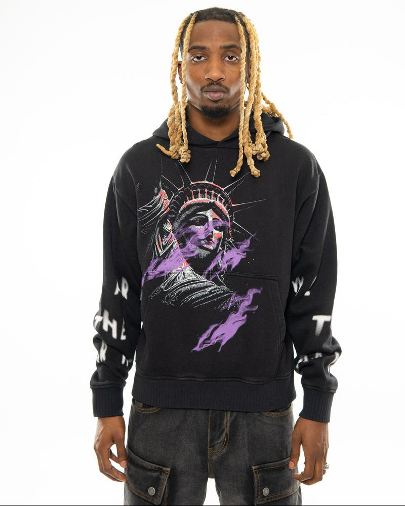 Person wearing a black hoodie with a graphic design on a white background