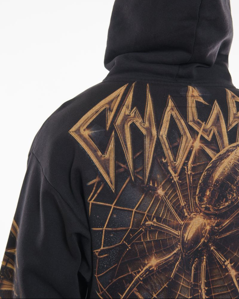 Black hoodie with gold graphic design on the back against a white background