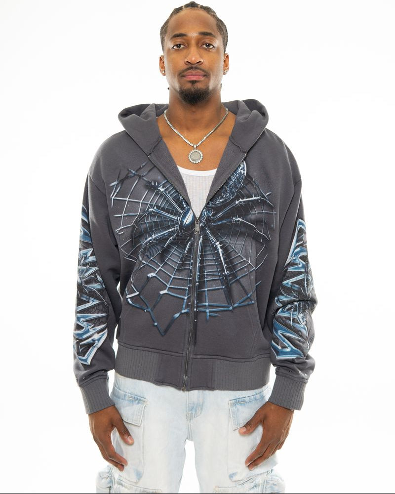 Man wearing a gray hoodie with spider web design on a white background