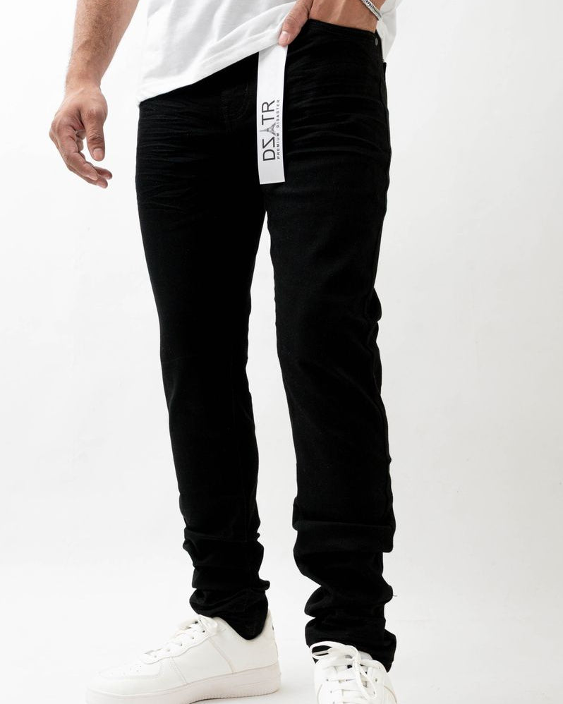 Person wearing black pants with a visible brand logo on a white background