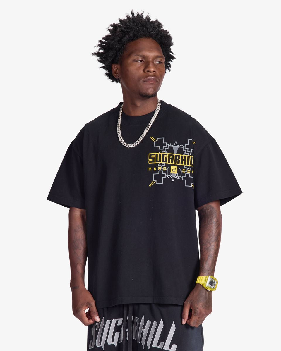 Man wearing a black t-shirt with yellow text on a white background