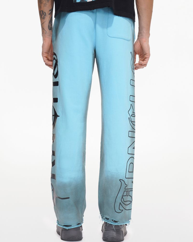 Light blue pants with text design worn by a person on a white background