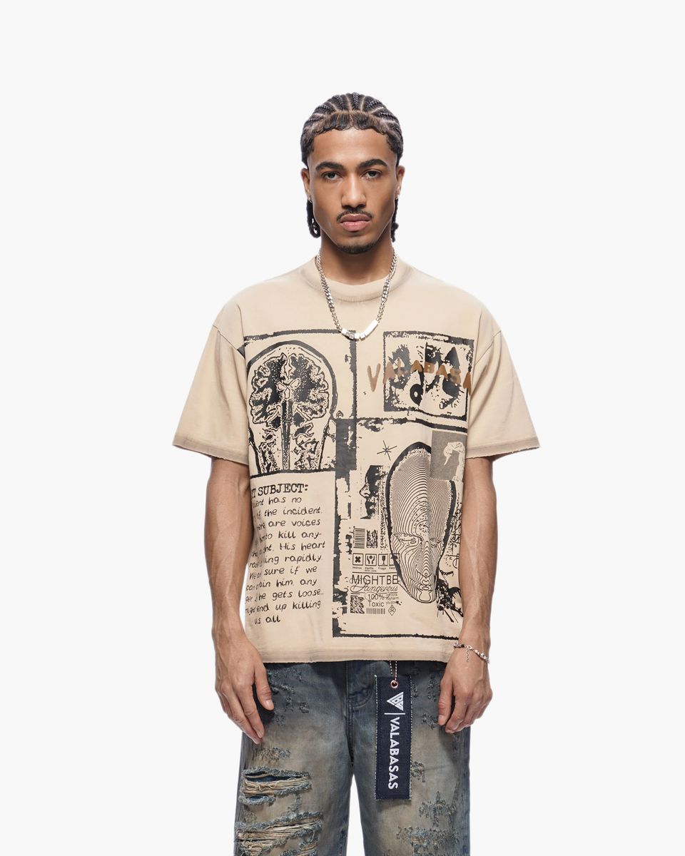 Person wearing a beige t-shirt with graphic design on a white background