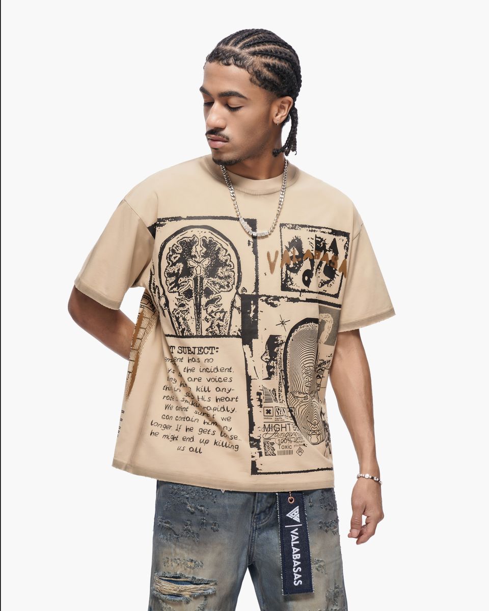 Man wearing a beige t-shirt with graphic design on a white background