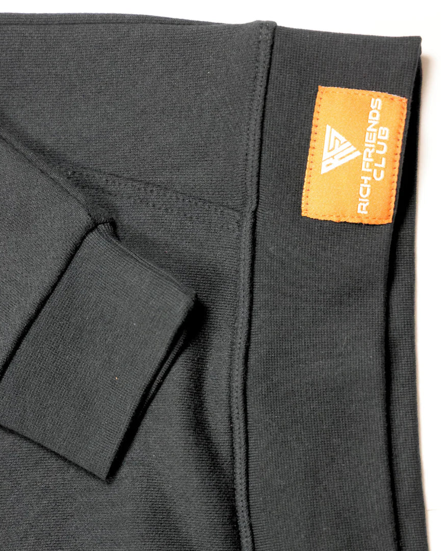 Black fabric with a visible brand tag on a white background