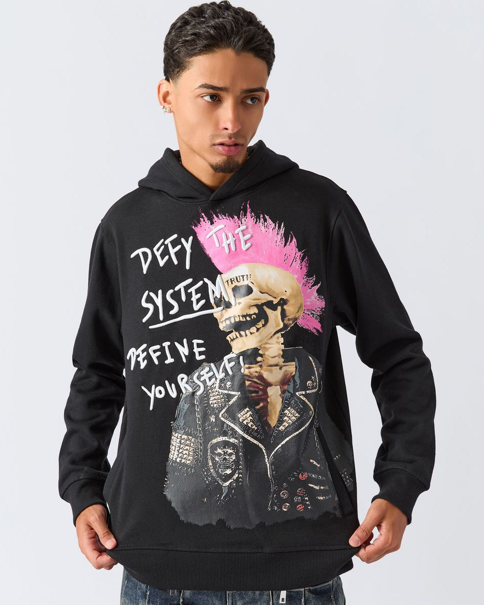 Person wearing a black hoodie with a graphic design and text on a plain background