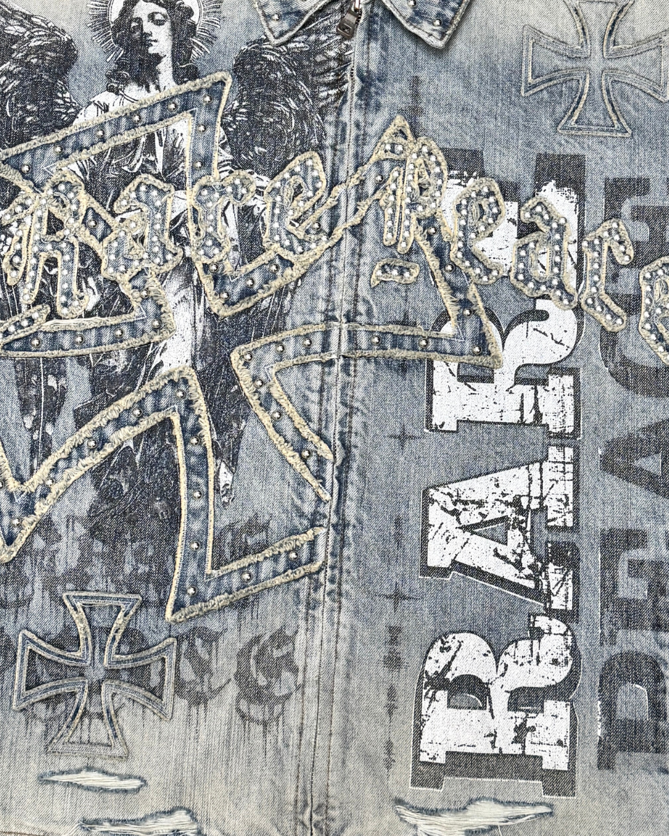 Close-up of a denim jacket with iron cross and 'Rat Fink' branding.