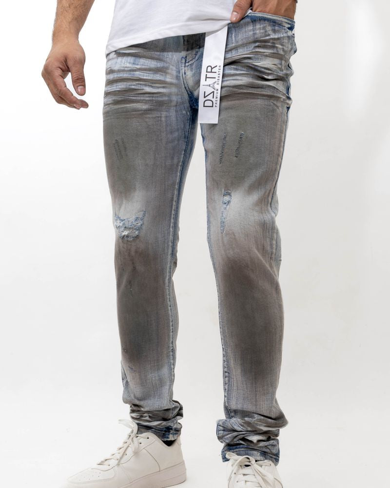 Person wearing gray distressed jeans with a white background