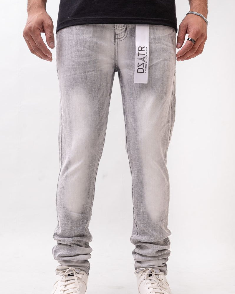 Person wearing gray jeans with a brand label on a white background