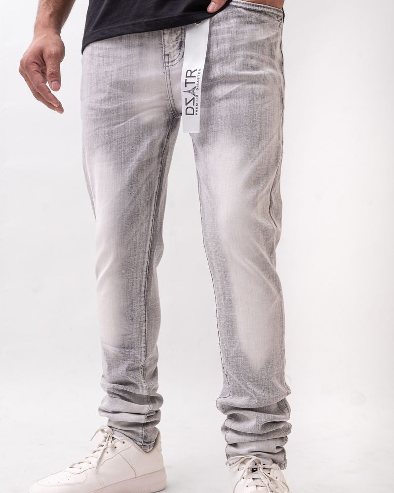 Person wearing light gray jeans with a visible brand logo on a white background