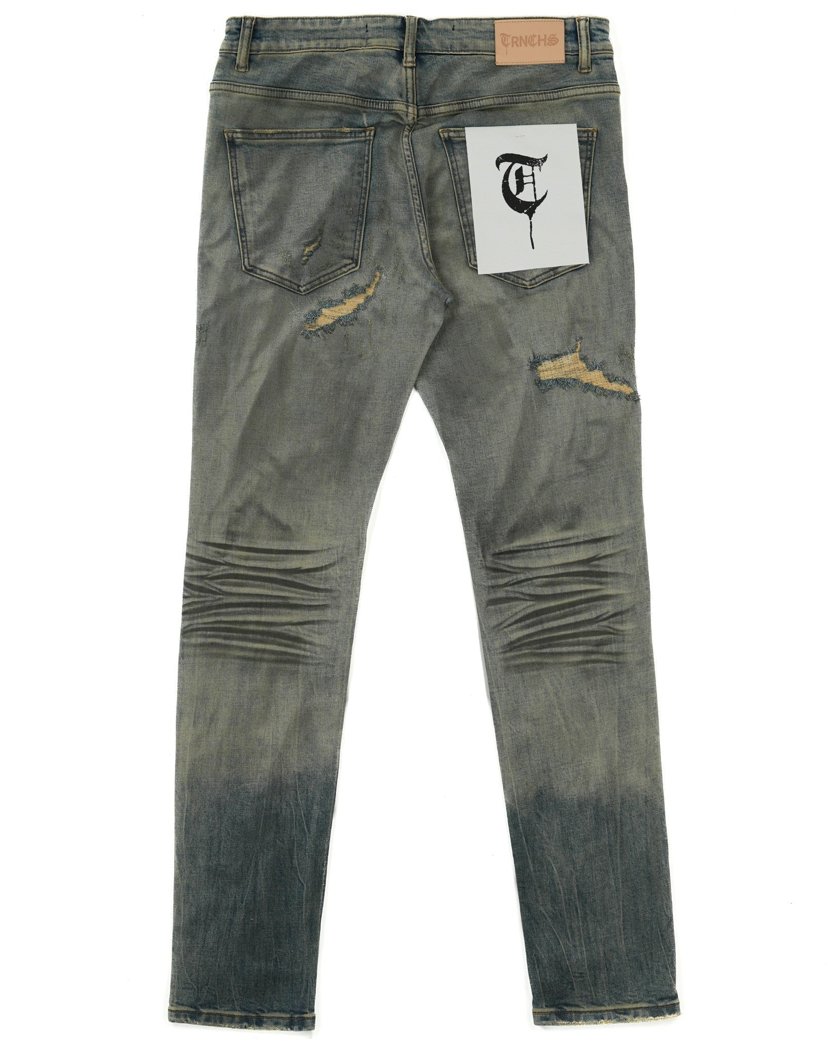 Distressed denim jeans with a brand label on a white background