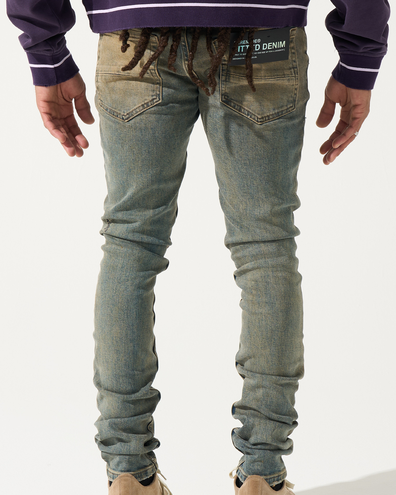 Person wearing blue jeans and a purple jacket with text on a white background