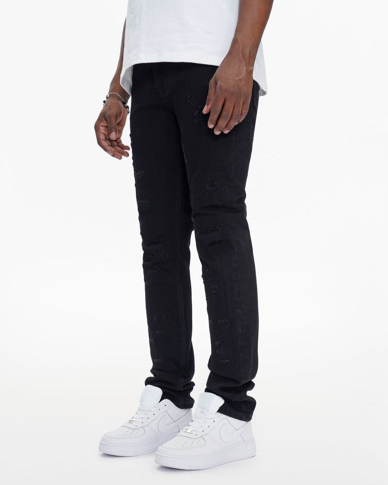 Person wearing black pants and white sneakers on a white background