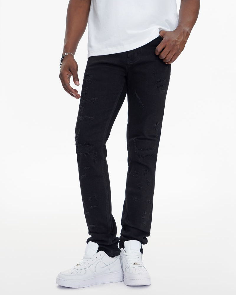Person wearing black pants and white sneakers on a white background