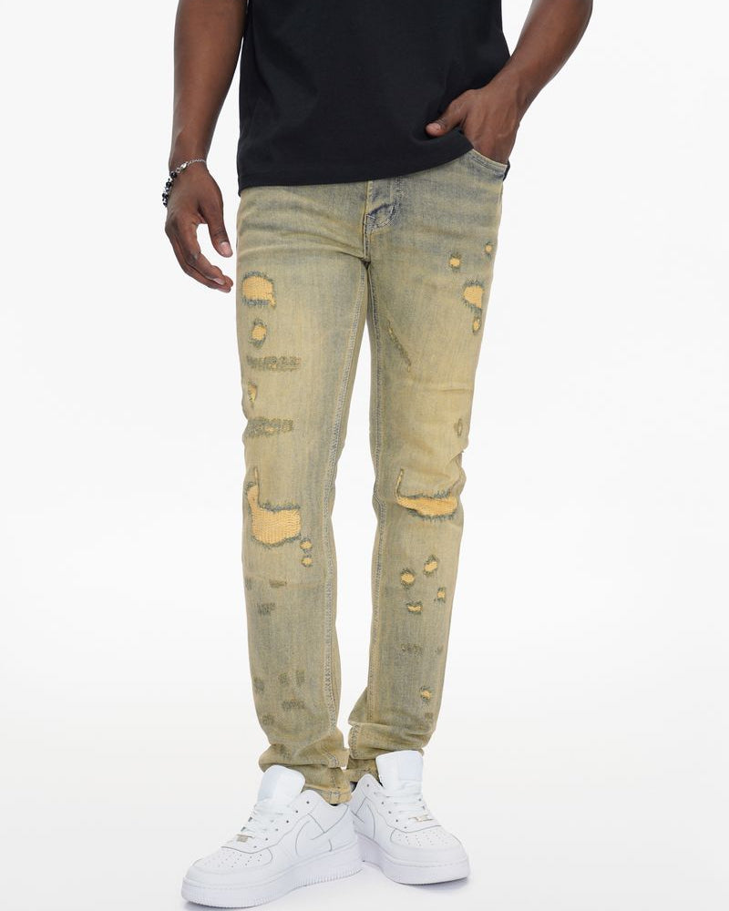 Person wearing light-colored distressed jeans and white sneakers on a white background