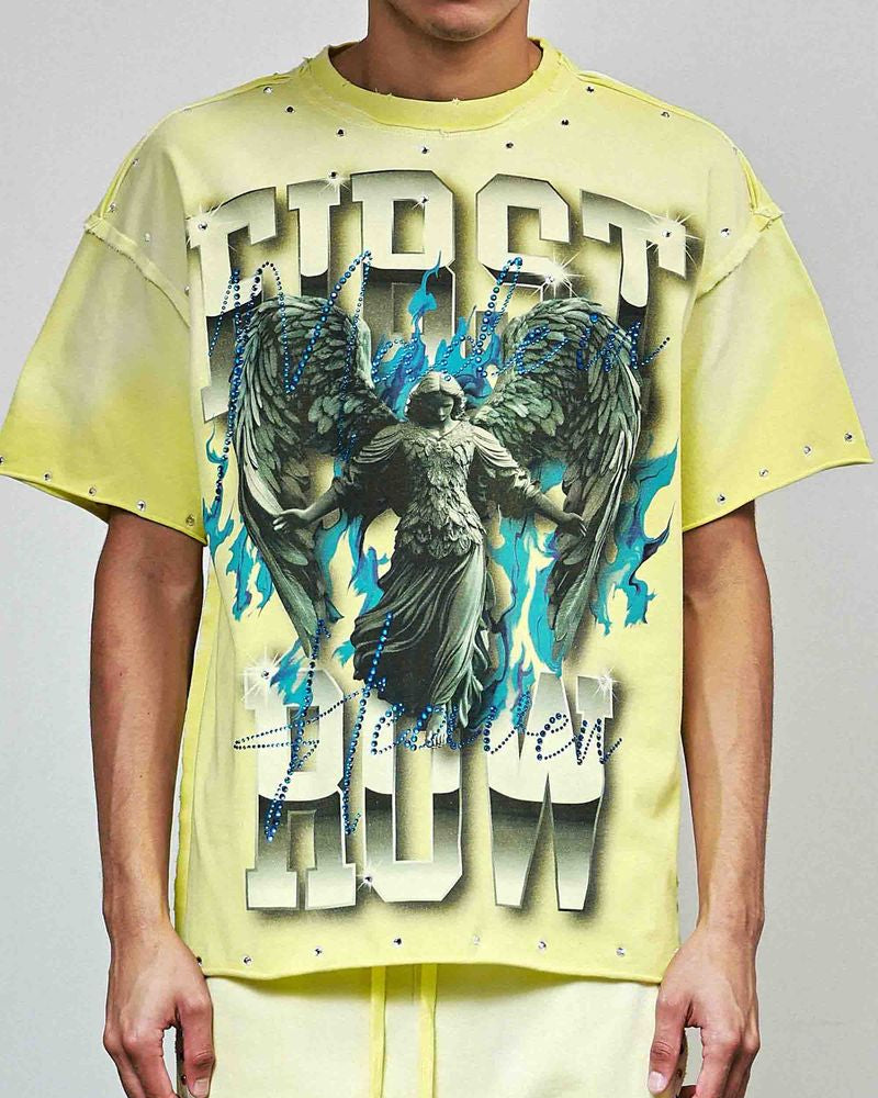 Person wearing a yellow t-shirt with graphic design and text