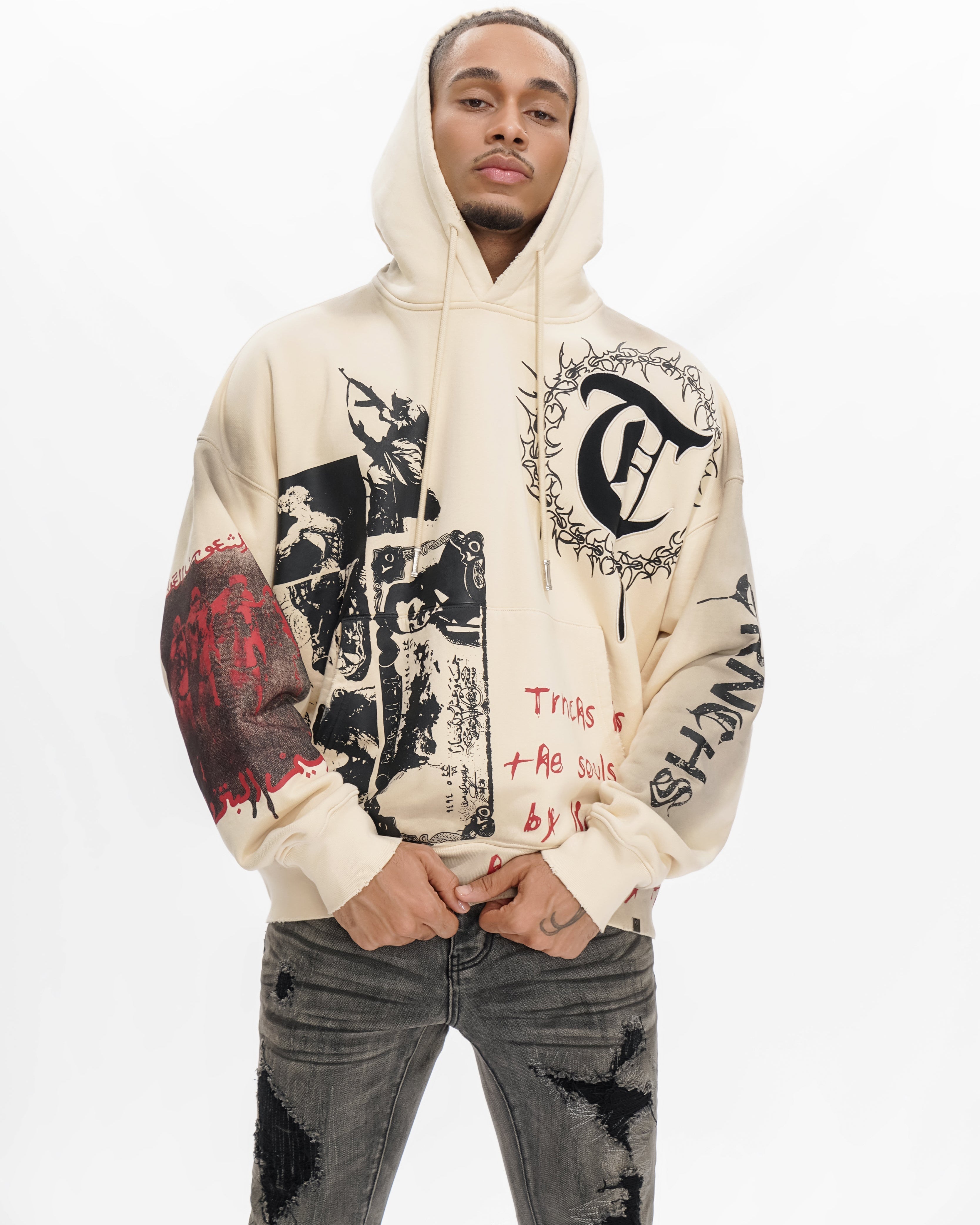 Person wearing a beige hoodie with graphic designs on a white background