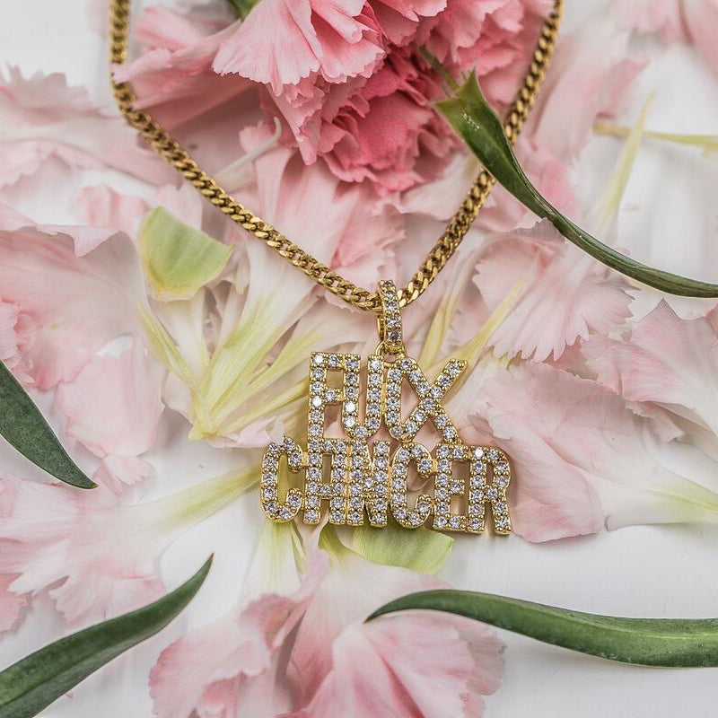 Gold necklace with a 'F**K CANCER' pendant on pink flowers