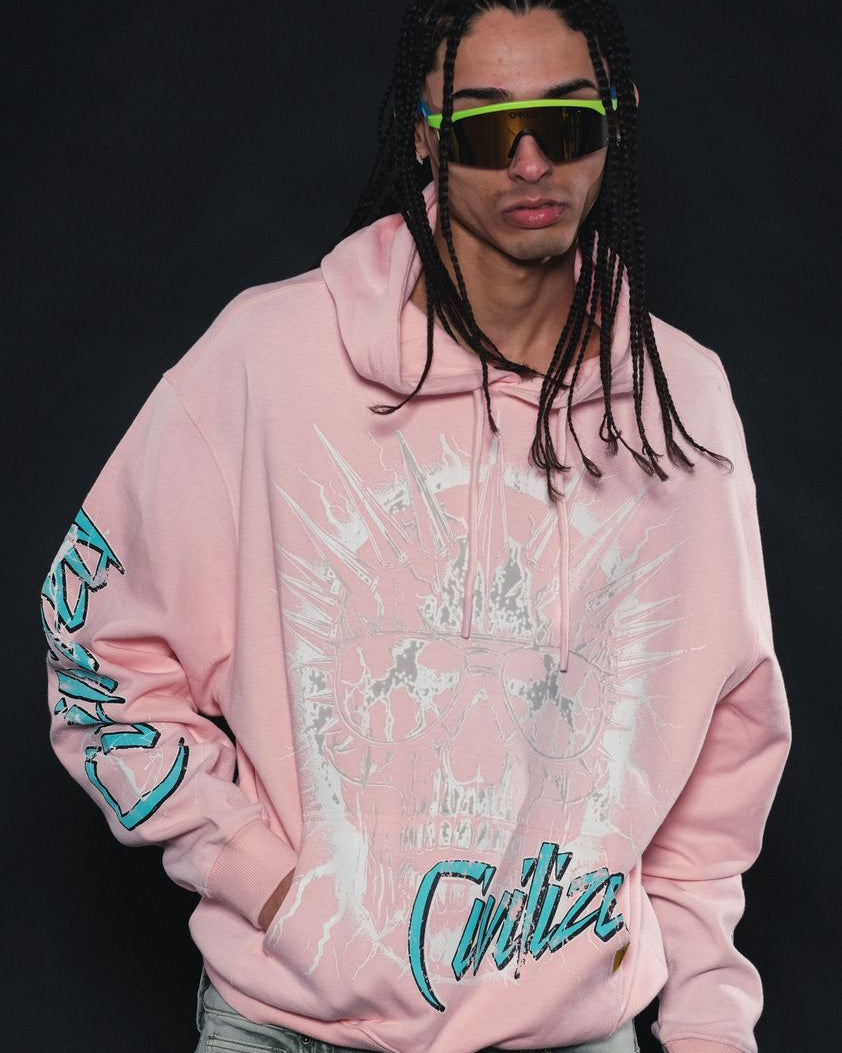 Person wearing a pink hoodie with teal text on a black background