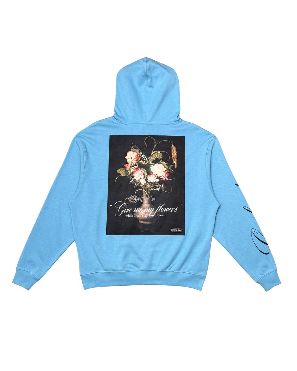 Light blue hoodie with floral design and text on a white background