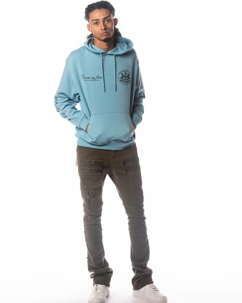 Person wearing a light blue hoodie and gray pants on a white background