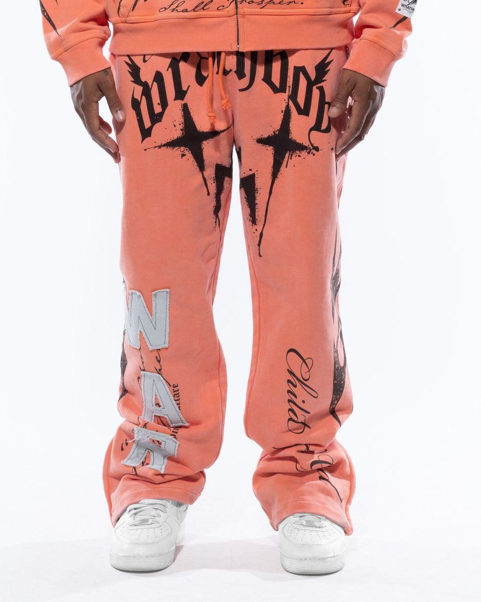 Person wearing a peach-colored hoodie and pants with graphic designs on a white background