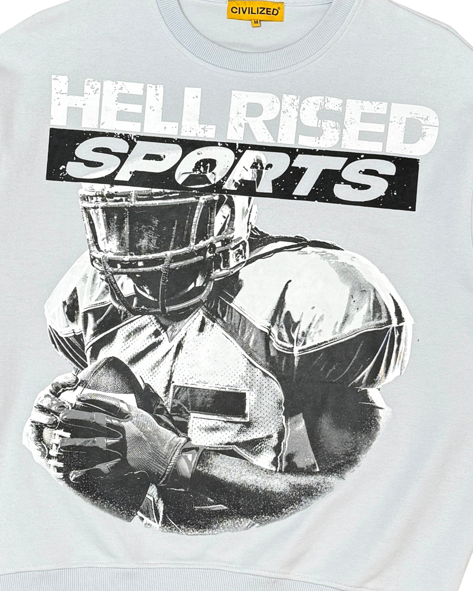 T-shirt with graphic of a football player and 'Hell Rised Sports' text on a light gray background