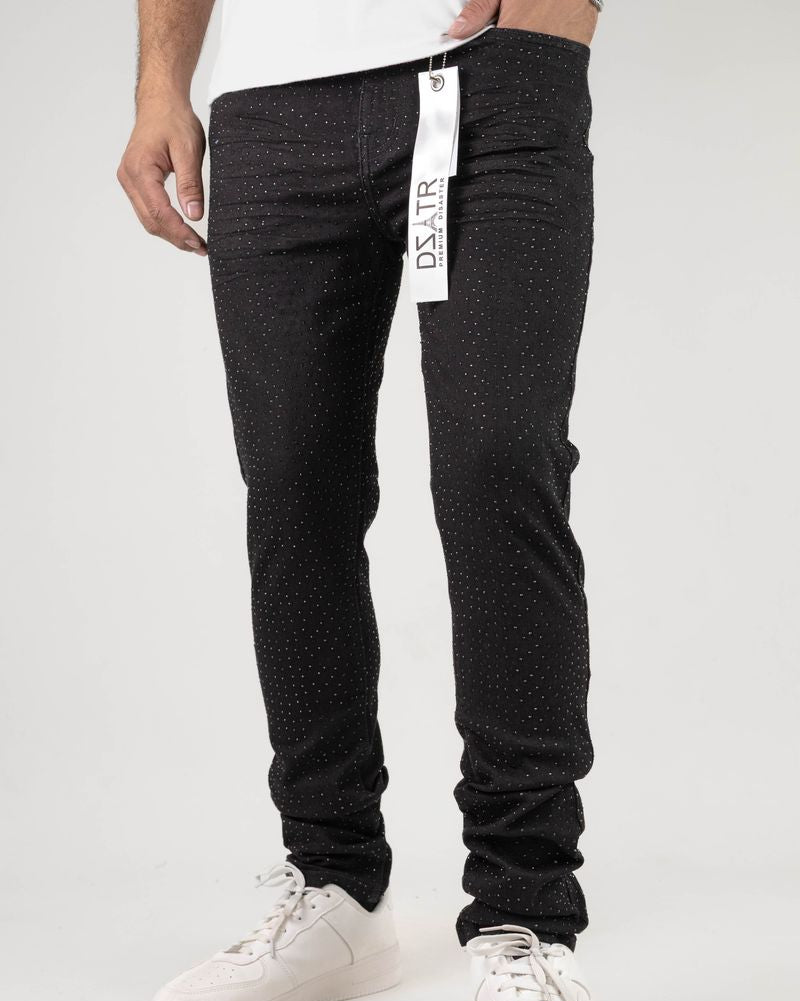 Person wearing black pants with a brand tag on a white background