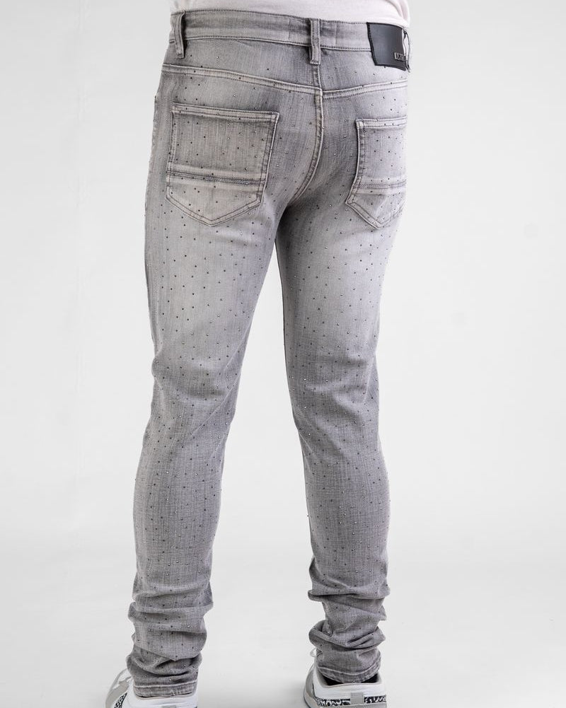Gray jeans worn by a person on a white background