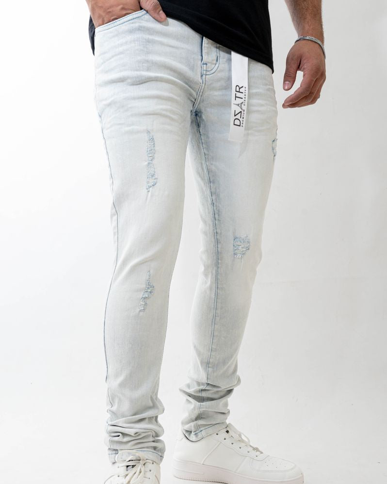 Light blue distressed jeans worn by a person on a white background