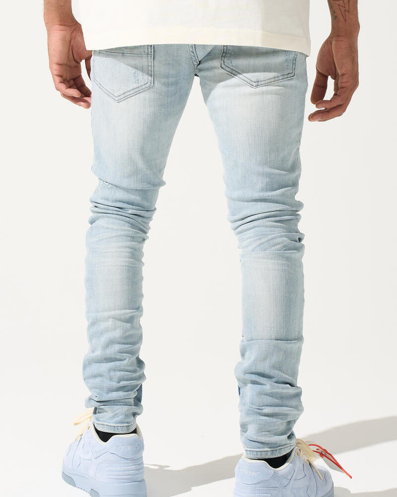 Light blue jeans worn by a person on a white background
