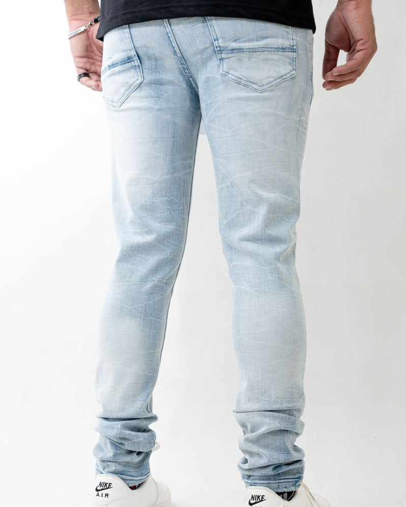 Light blue jeans worn by a person on a white background