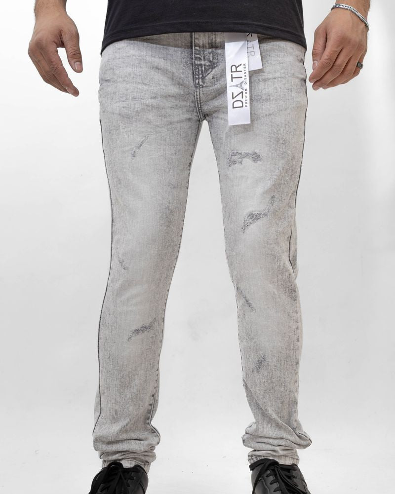 Person wearing gray distressed jeans with a visible brand label on a white background